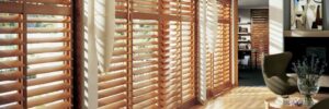 Modern interior with wooden blinds and chair.