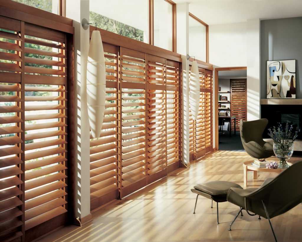 Modern interior with wooden blinds and chair.