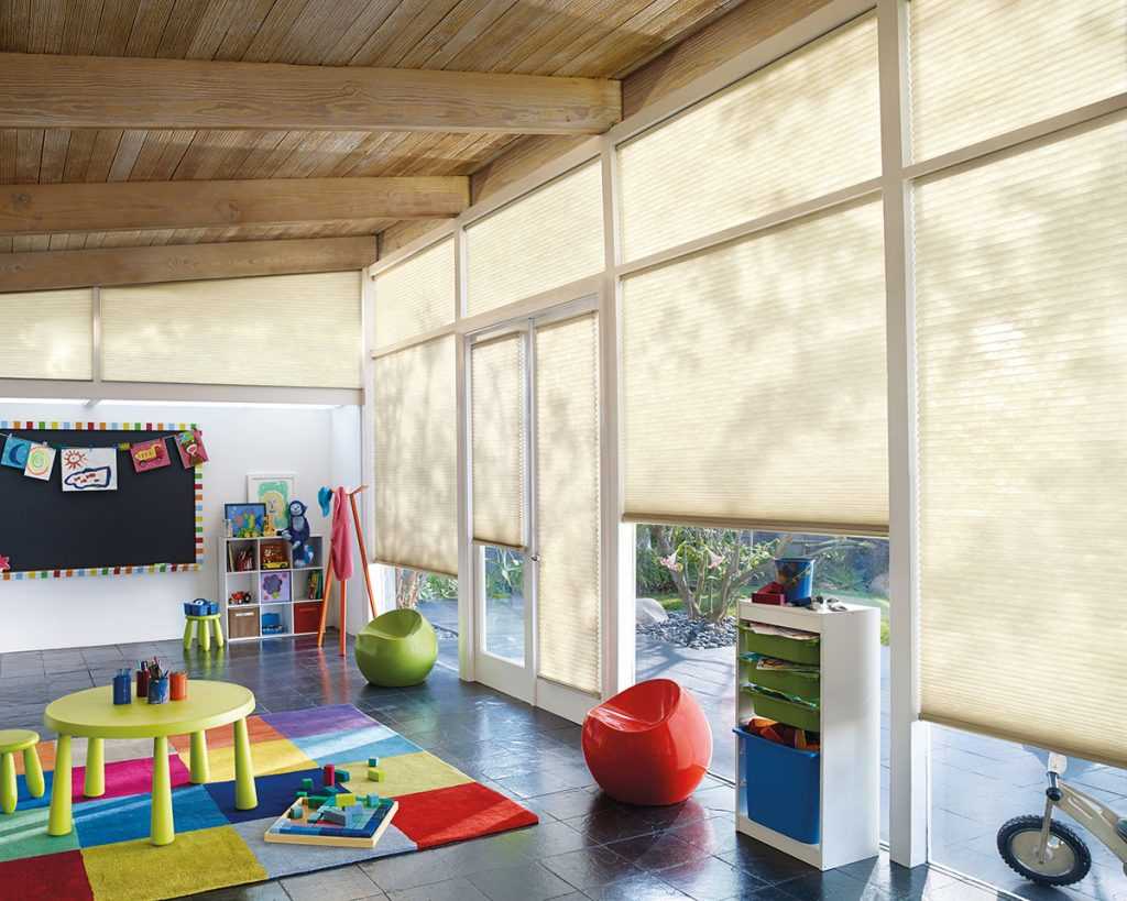 Bright playroom with colorful decor and blinds.