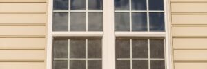 A window with four windows on the outside of a house.