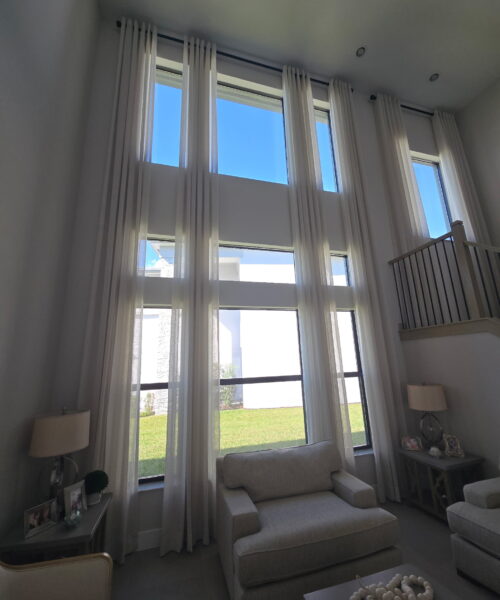 A living room with two windows and a couch