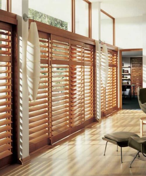Modern interior with wooden blinds and chair.